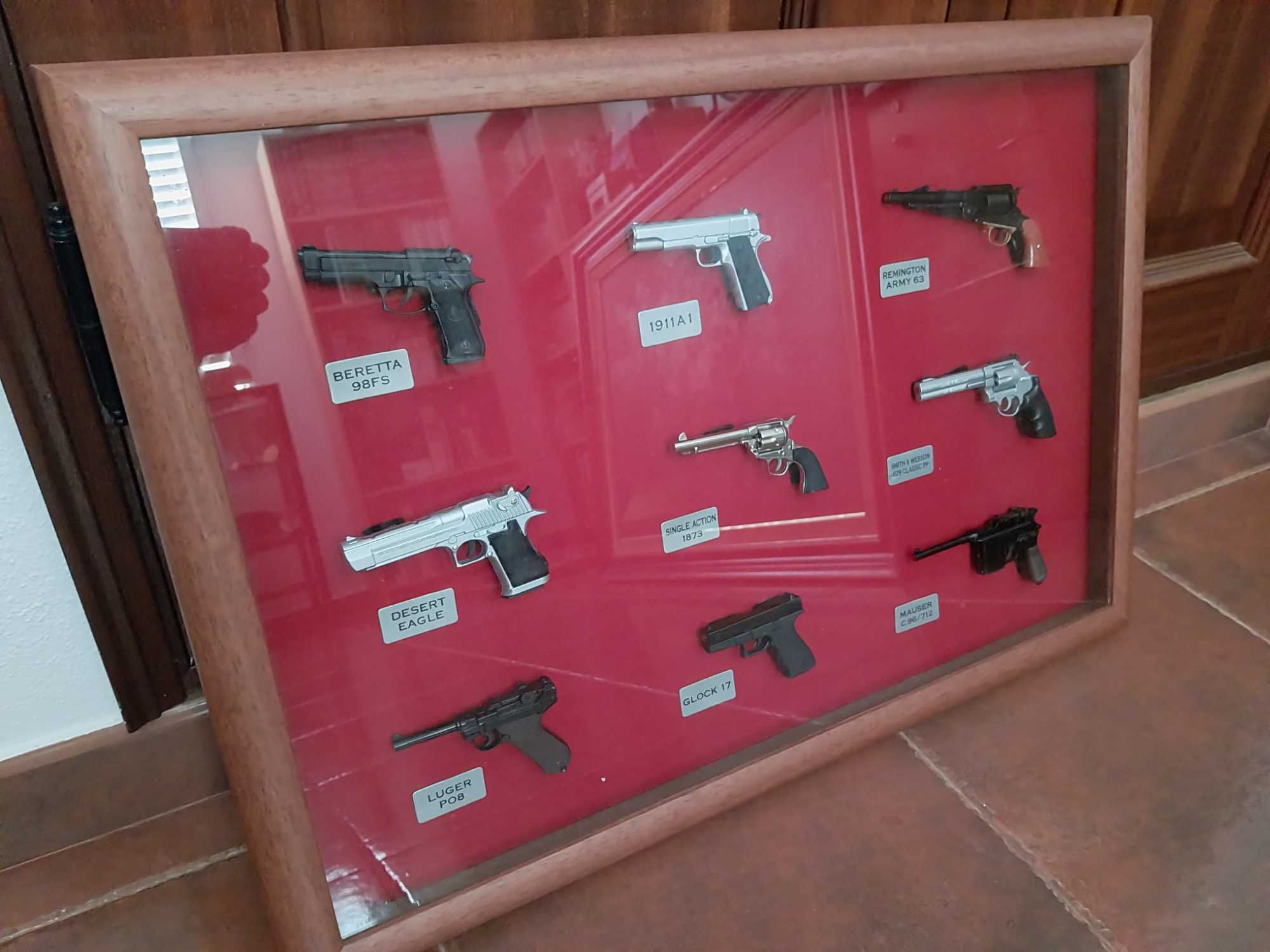 Quadros com miniaturas de pistolas