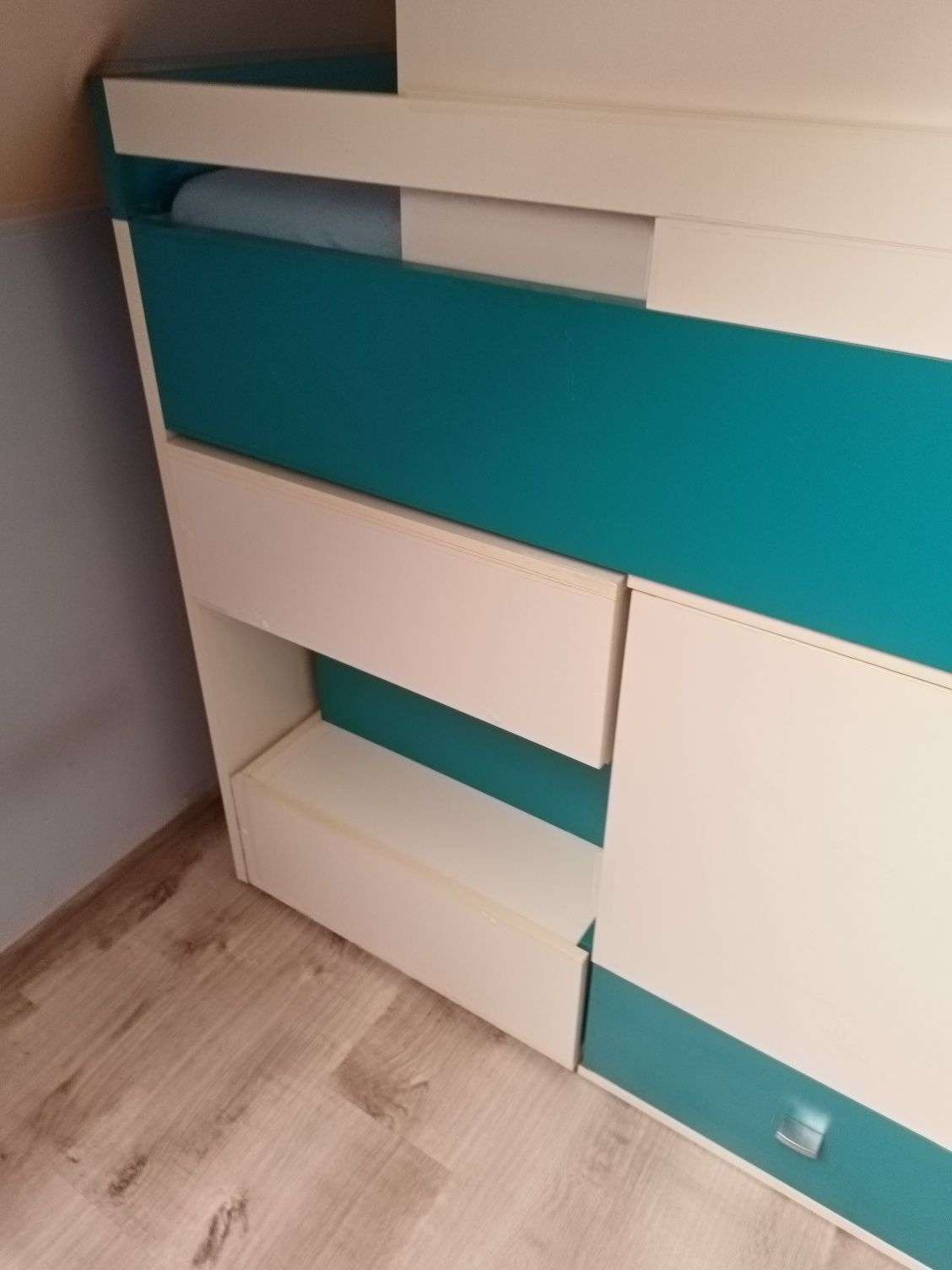 Łóżko piętrowe niskie z szufladami i wysuwanym biurkiem.
