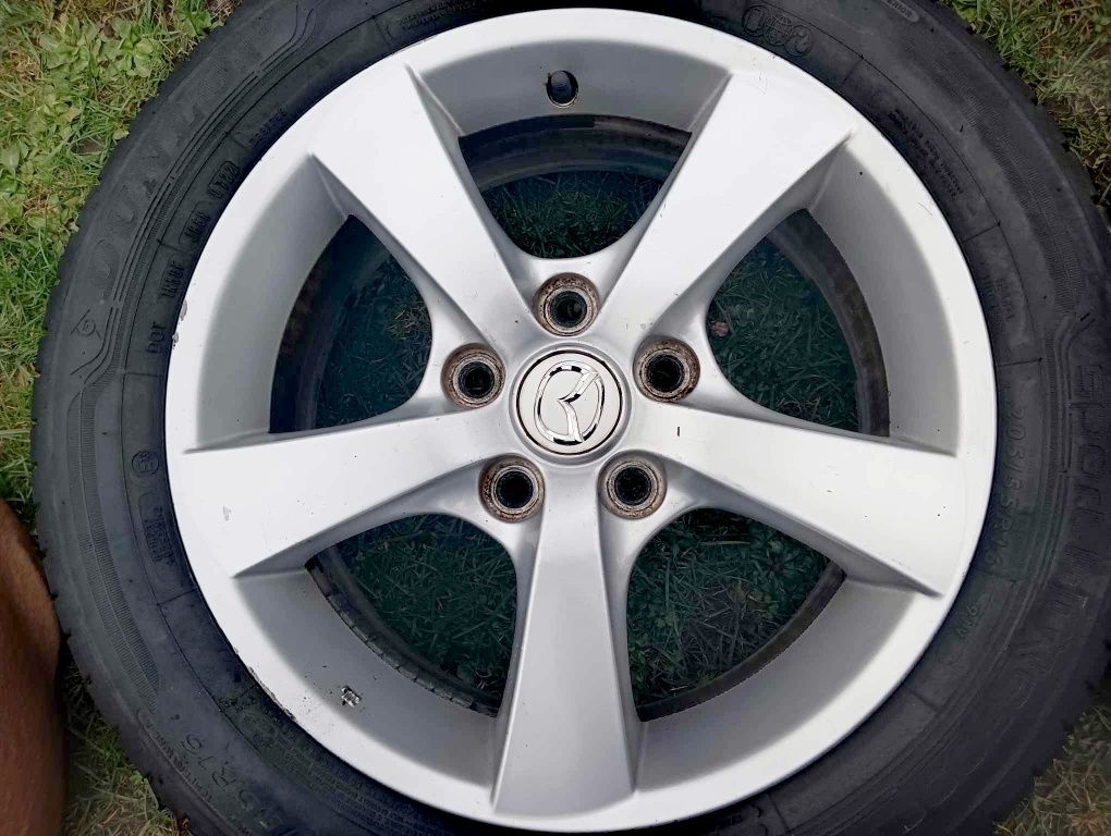 Oryginalne felgi aluminiowe mazda 16" z 2 letnimi oponami DUNLOP