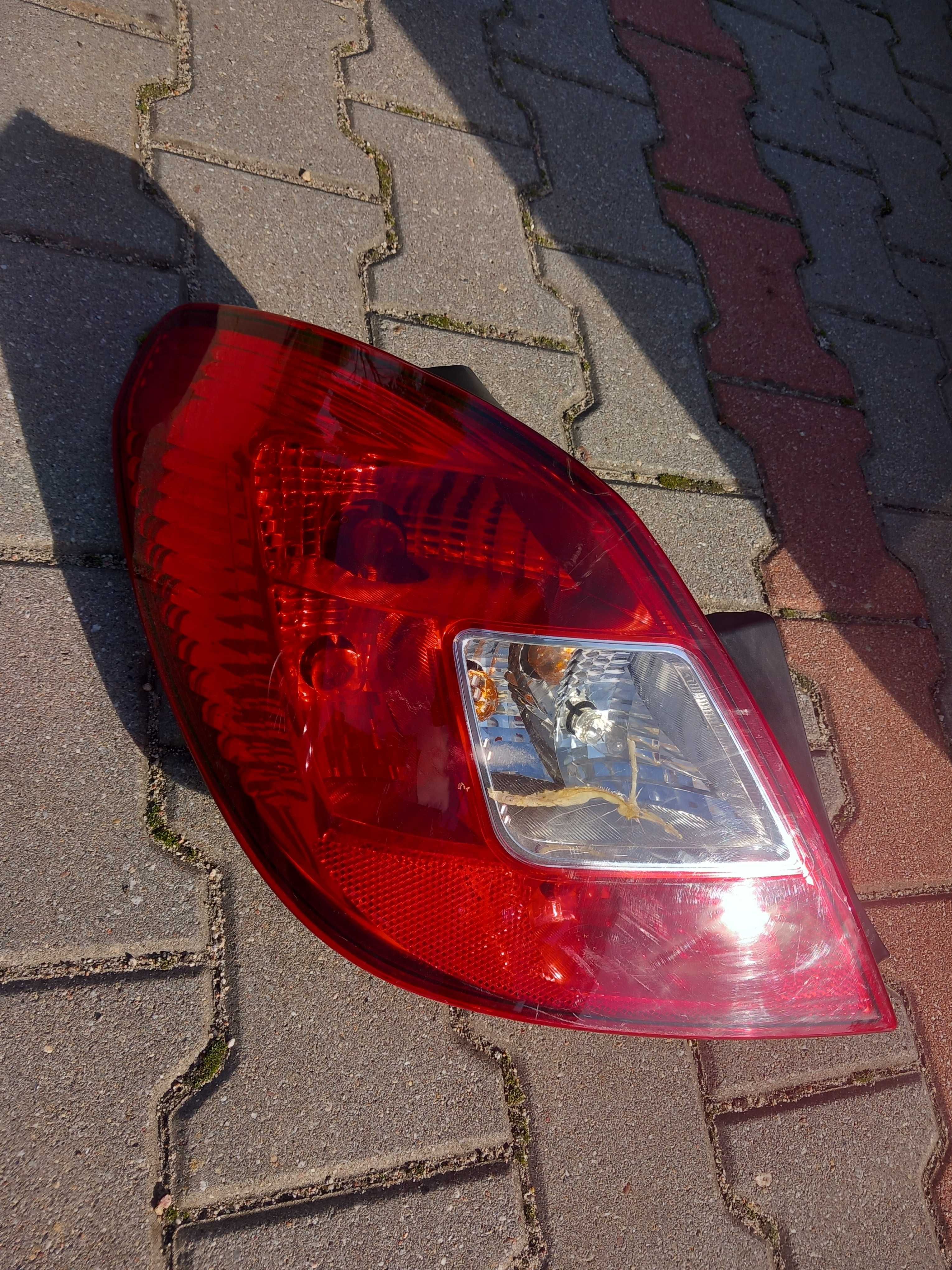 Lampa tył opel corsa d lewa reflektor lewy pajączek
