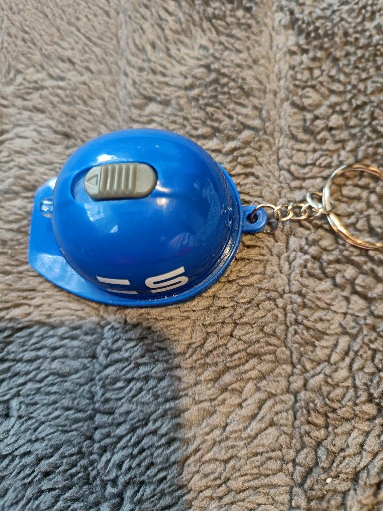 Breloczek do kluczy w kształcie kasku robotniczego.