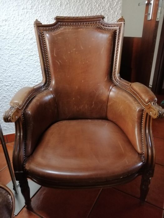 Cadeirão em pele e madeira talhada