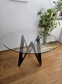 Stół szklany na trzech nogach