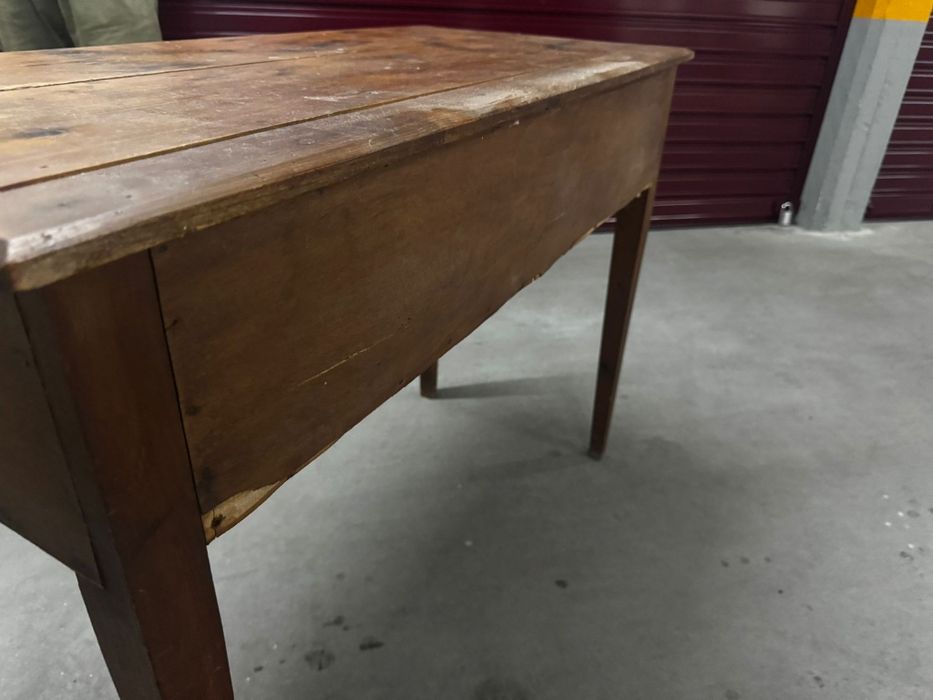 Antique wooden occasional table with a single drawer and tapered legs.