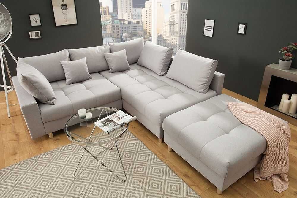 Elegancki narożnik do salonu z pufa i funkcją spania- super oferta