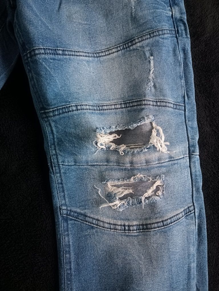SINSAY spodnie jogger z przetarciami rozm. 34