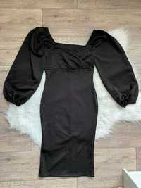 Чорна обтягуюча сукня з пишними рукавами