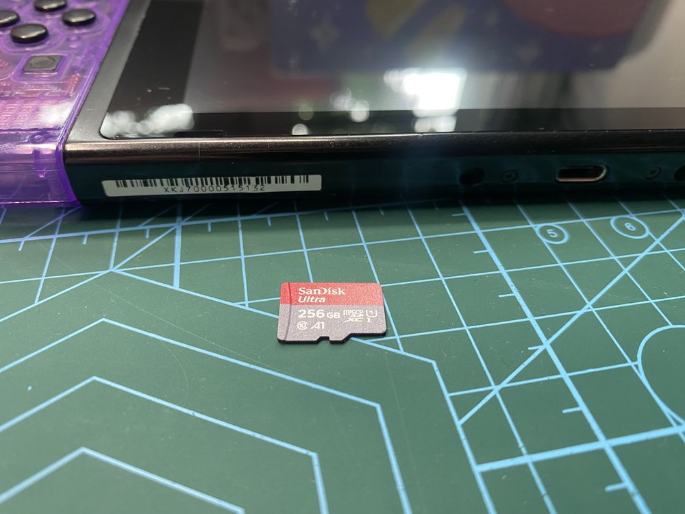 Nintendo Switch V2 - gałki magnetyczne, karta pamieci i fioletowy kolo