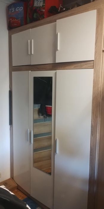 Szafa ubraniowa z półkami i wieszakiem.