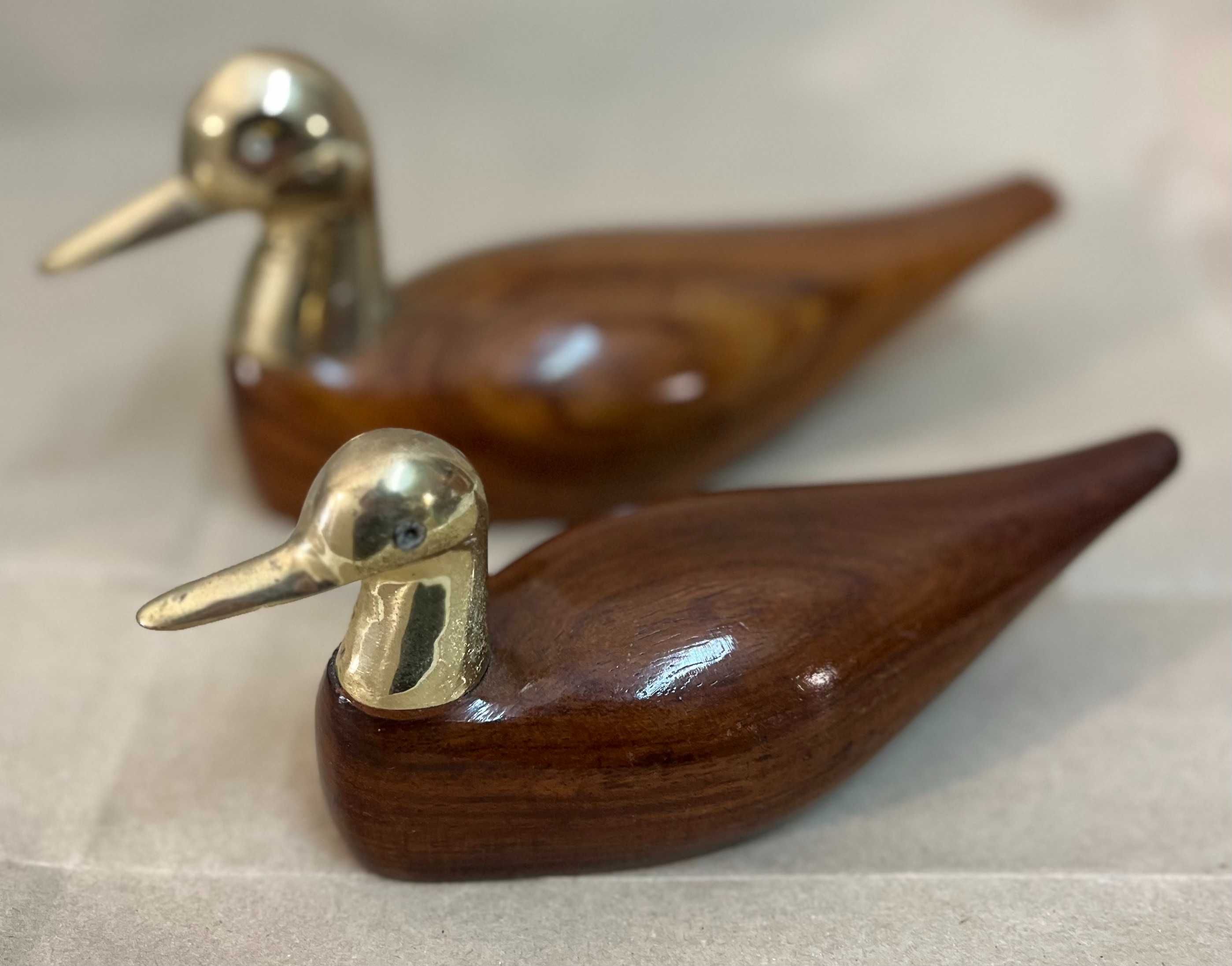Patos de madeira com adornos em latão