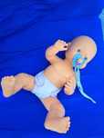 Boneca bébé com chupeta