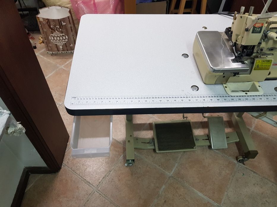 Máquina industrial corta e cose