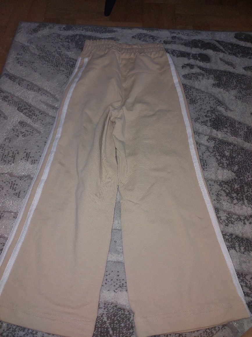 Beżowe spodnie dziewczęce Igomill rozmiar 116 - 122