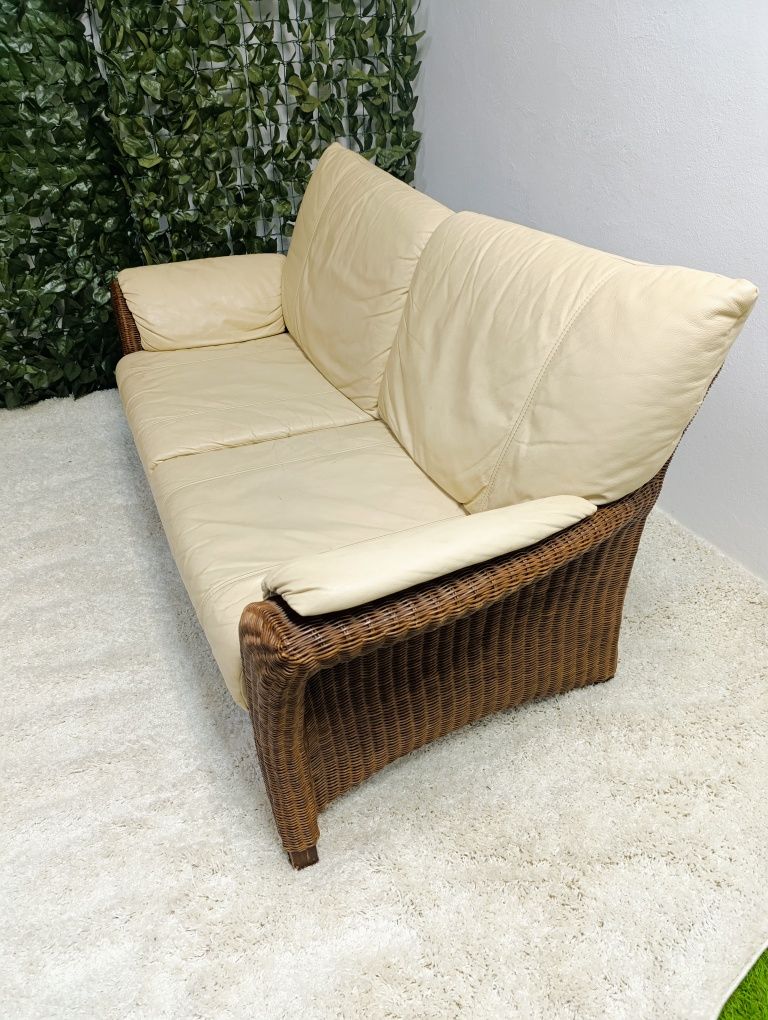Piekna sofa rattanowa z poduchami ze skóry naturalnej.