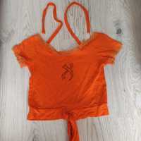Koszulka widać brzuch pomarańczowa wiązana na plażę
