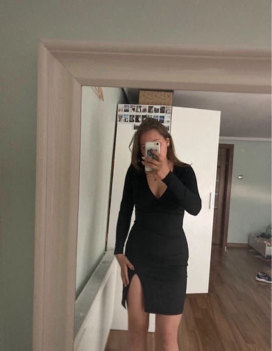 przepiękna, dopsowana czarna sukienka z długim rękawem i rozcięciem