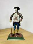 Stary zegar  figuralny ,, Sprzedawca zegarow „ sprawny