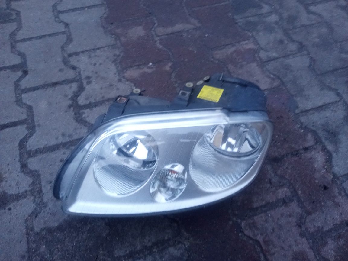 Reflektor lampa przednia lewa przód lewy VW caddy Turan