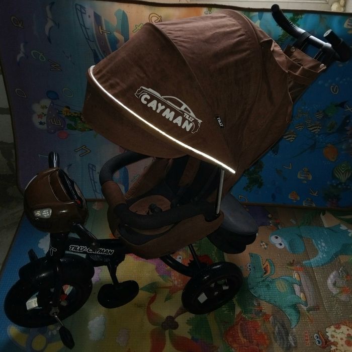 Продам детский музыкальный  велосипед-коляска Cayman.