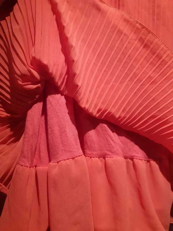 Plisowana różowa spódniczka do kolan, idealna na lato