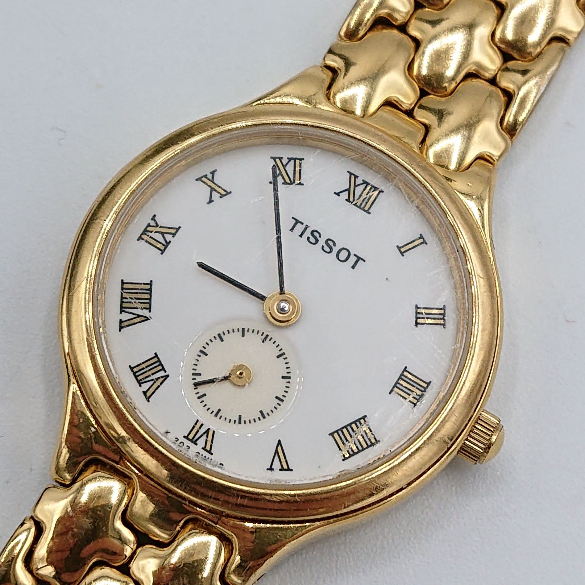 Жіночий позолочений годинник Tissot K 203
