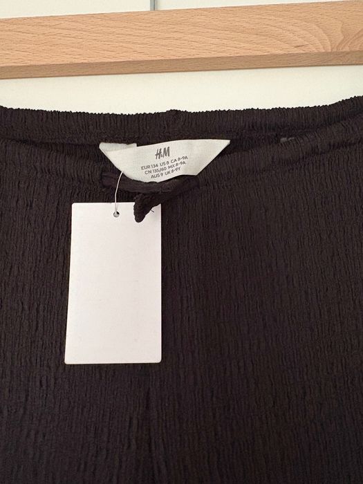 Czarne spodnie kreszowane H&M r.134