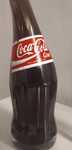 Coca cola. Garrafa. Vidro torcido.