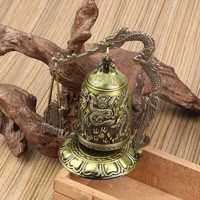 Metalowy dzwonek, rzeźbiony smok, zegar buddyjski.