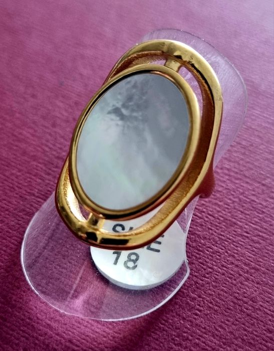 Anel dourado, em aço, com madrepérola oval. T18