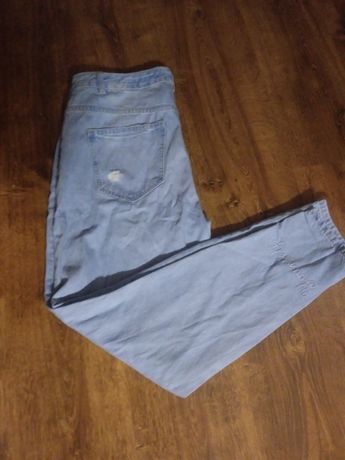 Spodnie jeansy damskie reserved z przetarciami 42