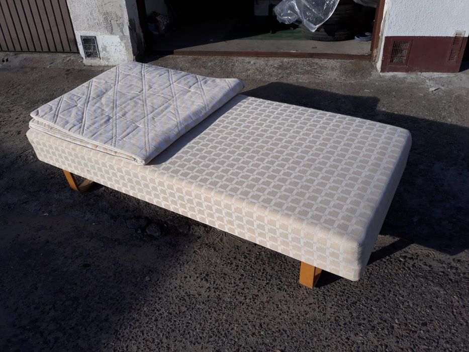 Jednoosobowe łóżko z materacem.