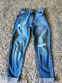 Spodnie dziewczęce jeansy z przetaciami 134 cm