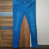 Niebieskie spodnie jeansowe  dopasowane rozm. 28