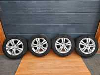 KOŁA FELGI ALUMINIOWE OPONY WIELOSEZONOWE 15 CALI OPEL ASTRA G H MERIVA A CORSA C D 4X100 185/65/15