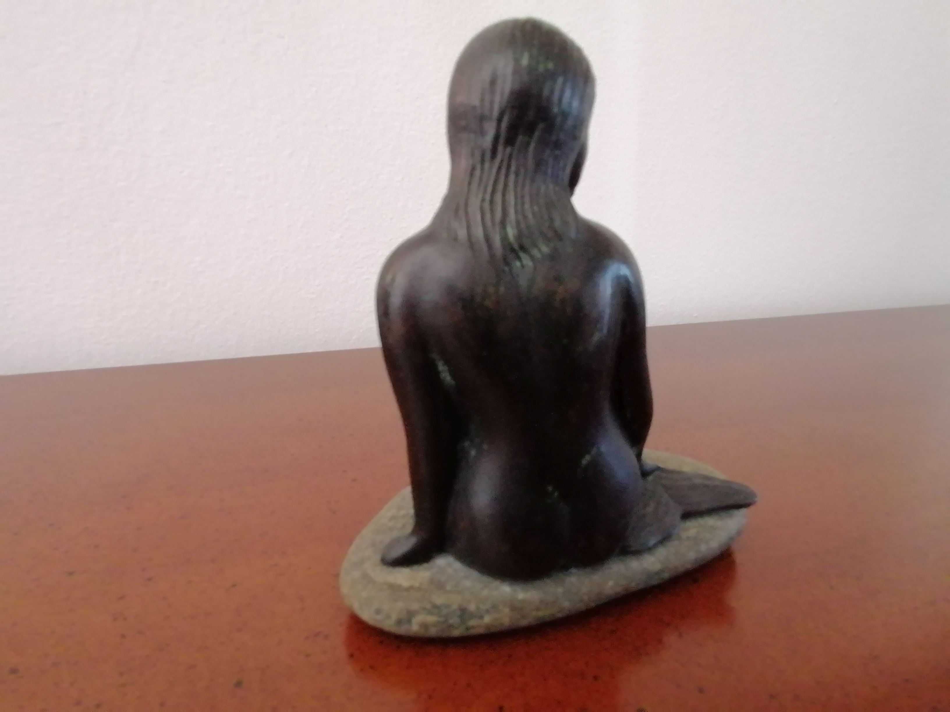 Escultura da pequena sereia em metal e com a base em pedra