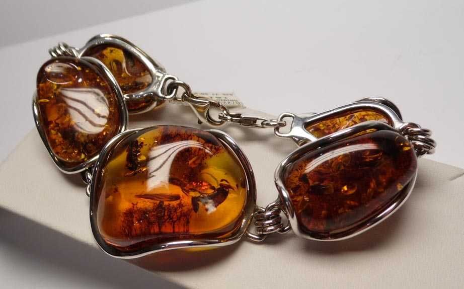 Srebrna okazała bransoletka z bursztynami.