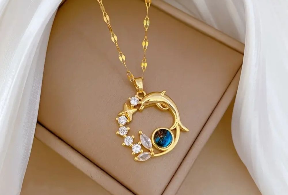 Złoty wisiorek z delfinem i gwiazdkami