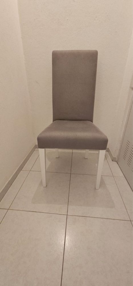 Mesa branca com 4 cadeiras cinzas