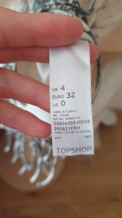 Krótki kremowy crop top z frędzlami bawełna wzory trochę aztec XXS