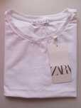 Tshirt branca zara nunca usada, na etiqueta. Altura no a cós da calça.