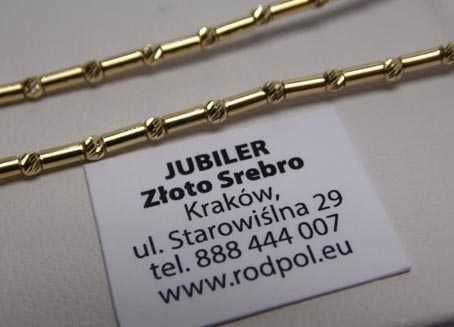 Złoty naszyjnik szczebelki i diamentowane kulki.