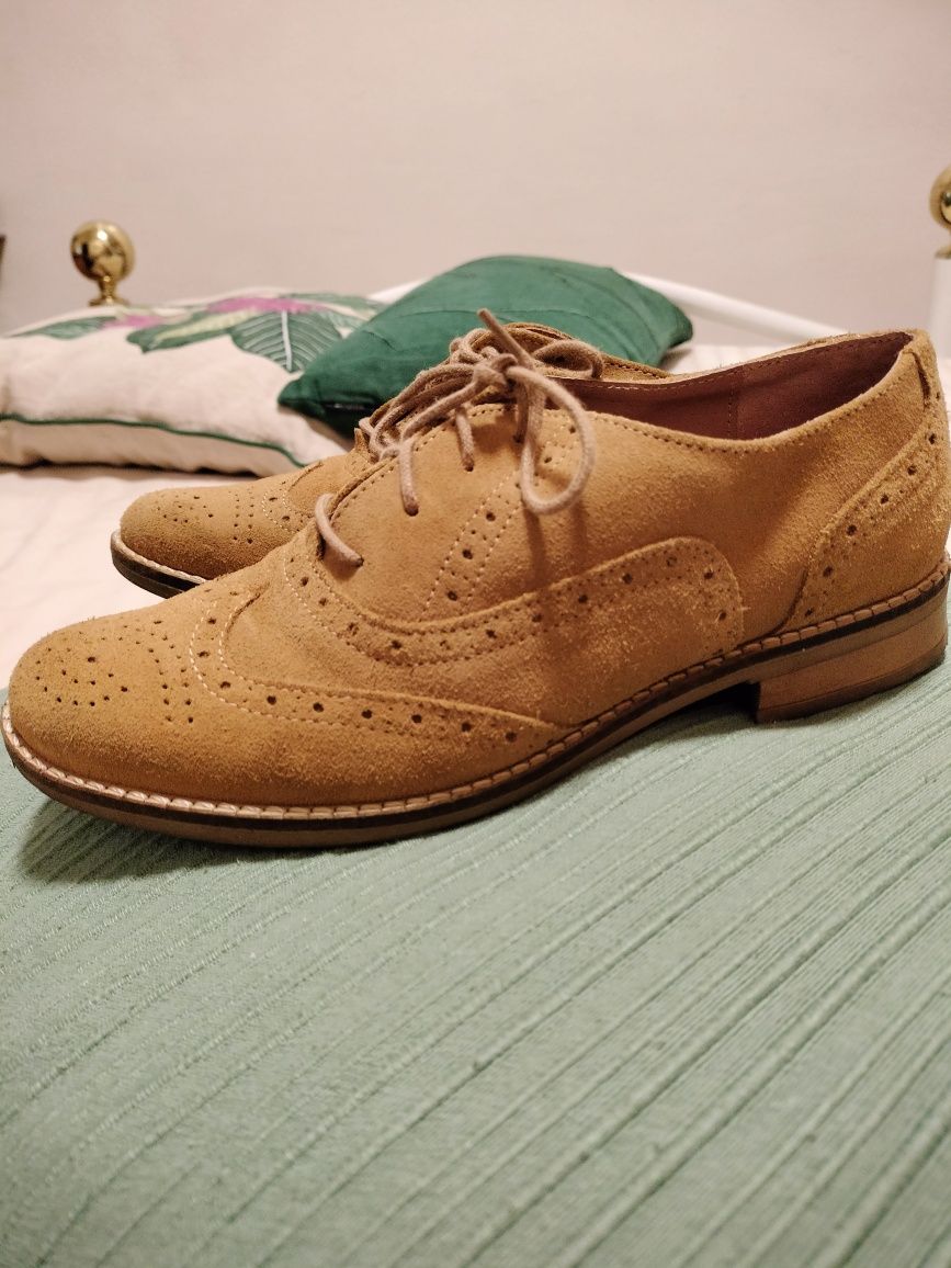 Sapatos com biqueira rdonda com atacadores em tecido tipo camurça.