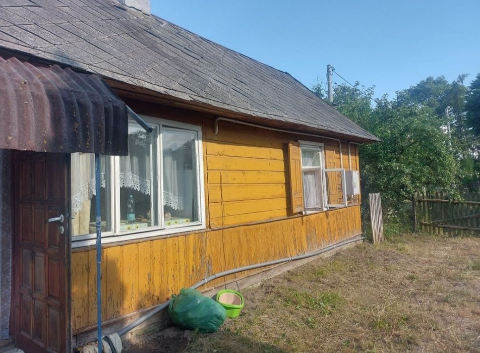 Dom drewniany z murowaną przybudowka.