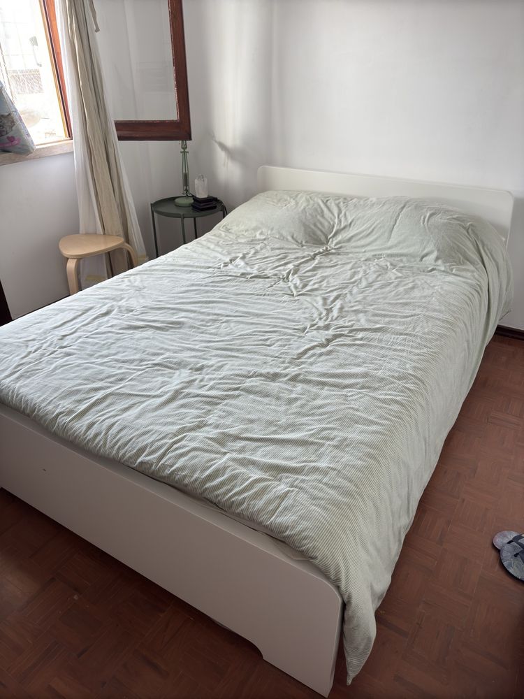 Estrutura de cama branca e colchão de mola IKEA com 140x200.