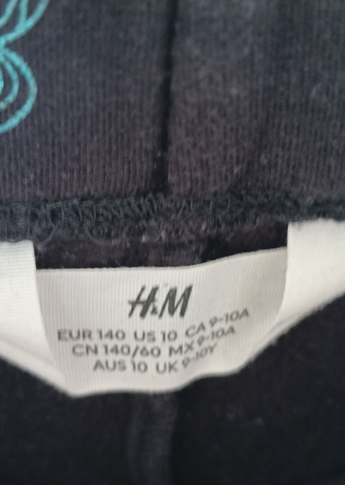 Czarne legginsy w kolorowe jednorożce H&M