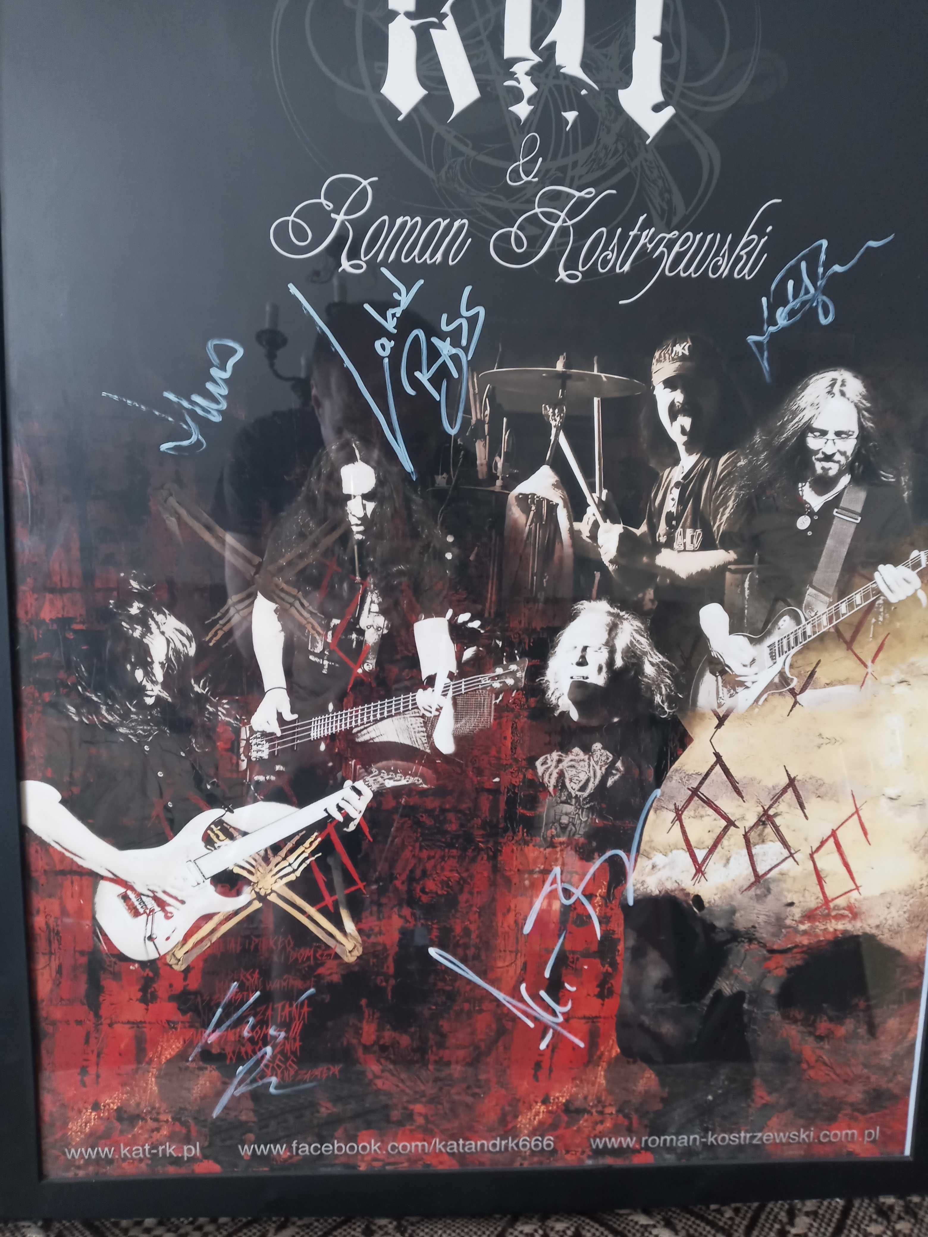 Plakat grupy KAT z autografami grupy w ramie.