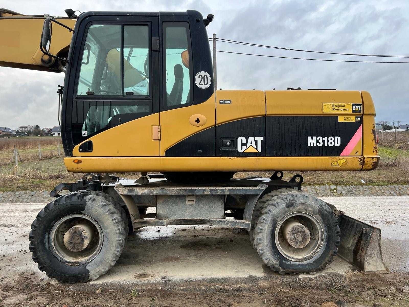 Koparka Caterpillar M318D. Pług, hydrauliczna łyżka skarpowa. Fv.