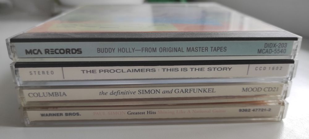 Buddy Holly, Proclaimers, Simon & Garfunkel, Paul Simon Фирменные CD