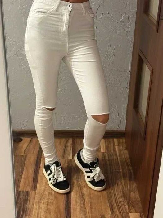 Białe dżinsy z rozdarciami na kolanach