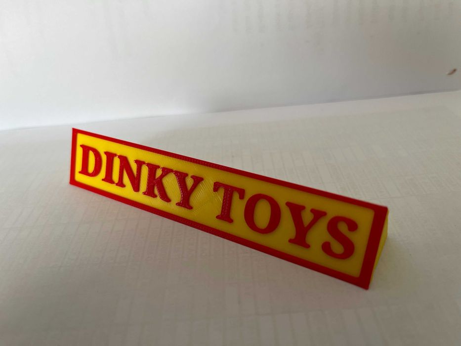 Sinal DINKY TOYS p/expositor miniaturas, paral. triang.reg., amarelo